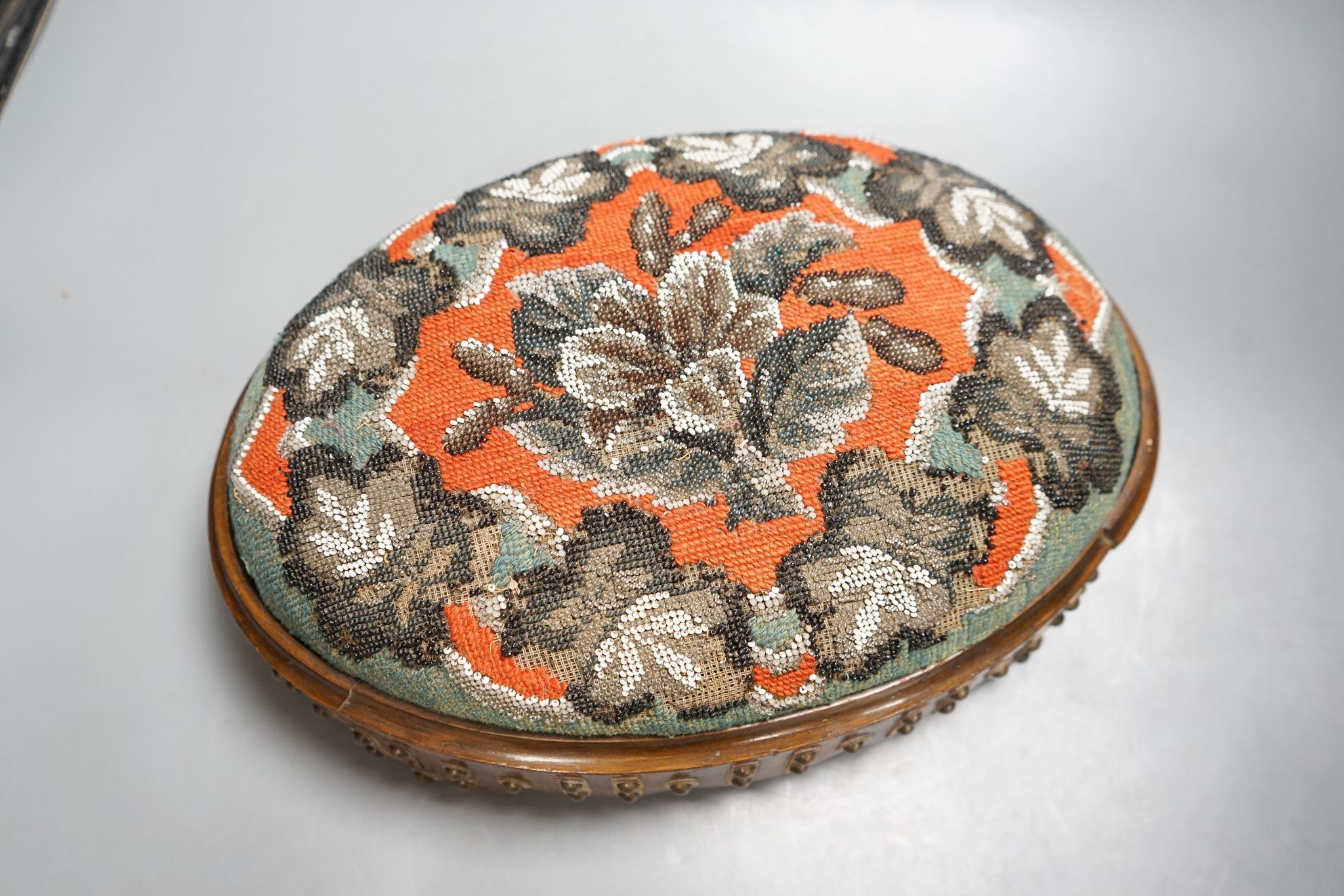 A pair of Berlin beadwork footstools, 38cm